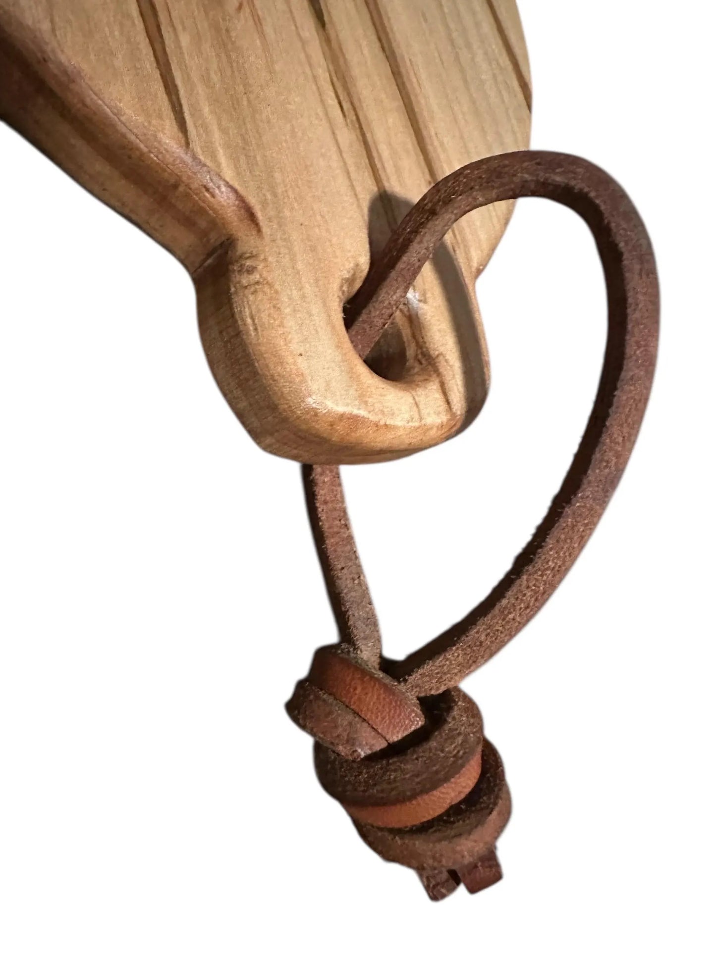 Wooden handle with a leather strap and knot on a white background