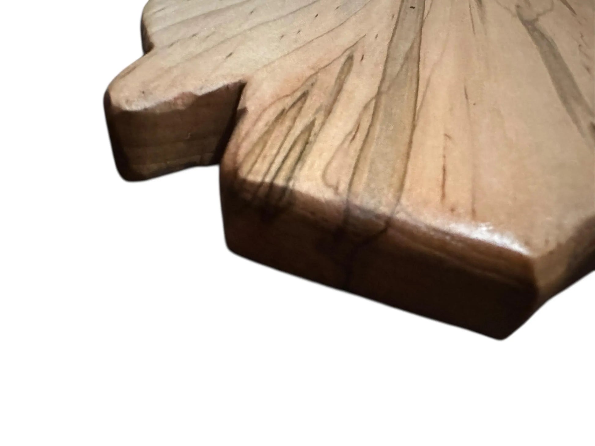 Close-up of a wooden leaf-shaped object on a white background