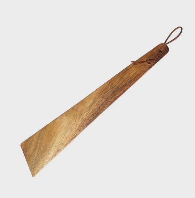 Wooden paddle with a handle on a light gray background