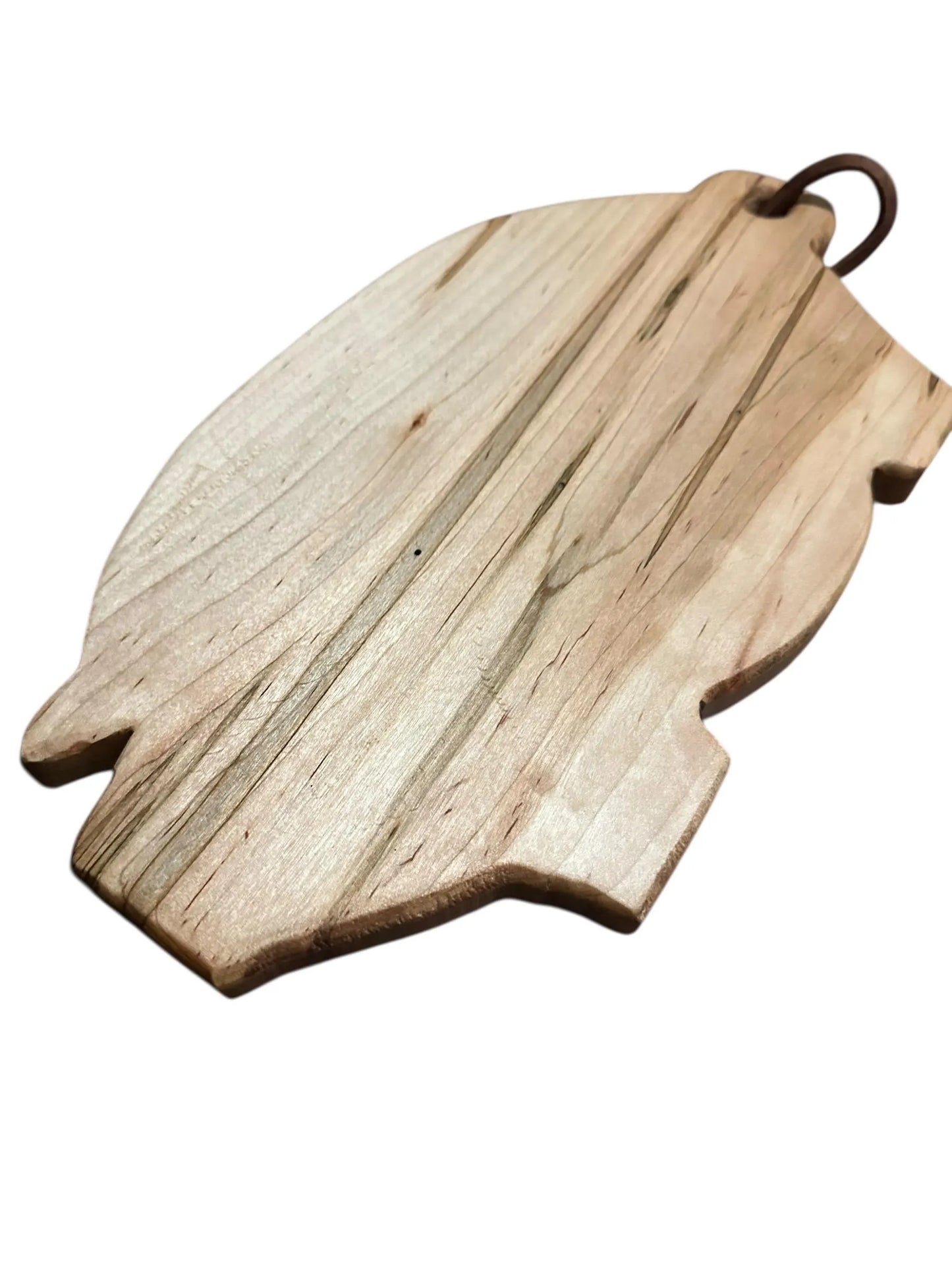 Wooden cutting board shaped like a leaf on a white background