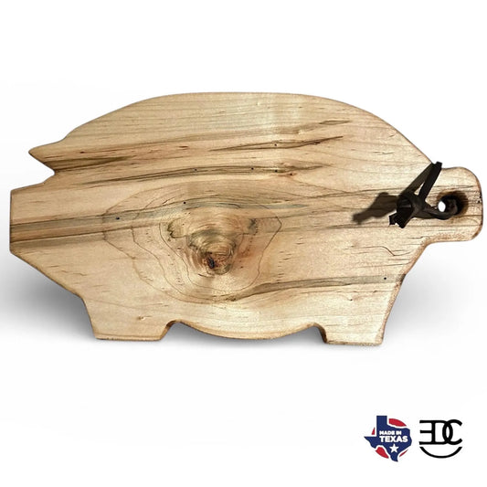 Wooden cutting board shaped like a pig with a Texas flag logo in the corner