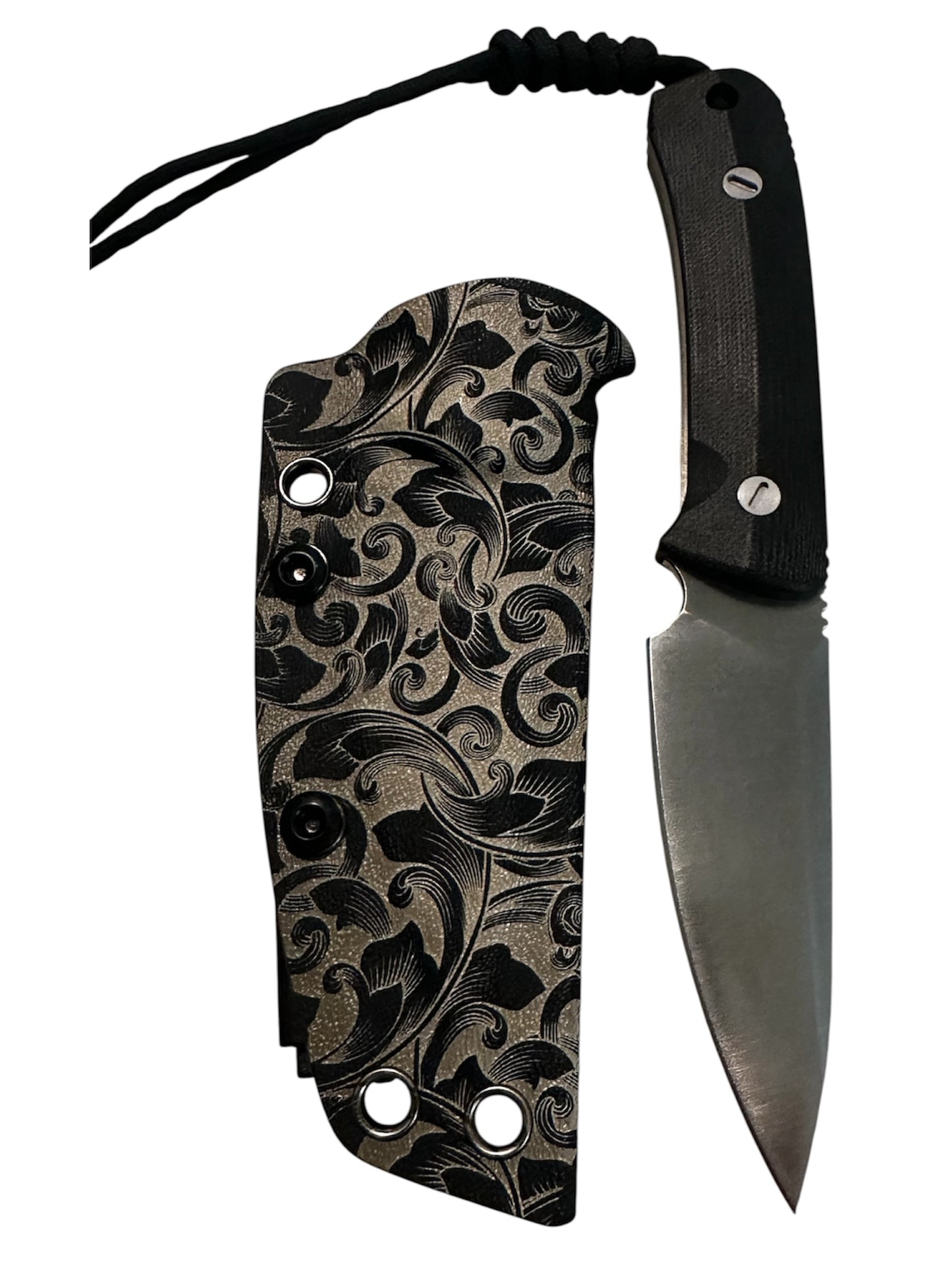 Compact 7-inch D2 fixed blade featuring black Micarta scales, custom floral engraved Kydex sheath, black paracord lanyard, and complimentary RockinEDC Steel Wax.