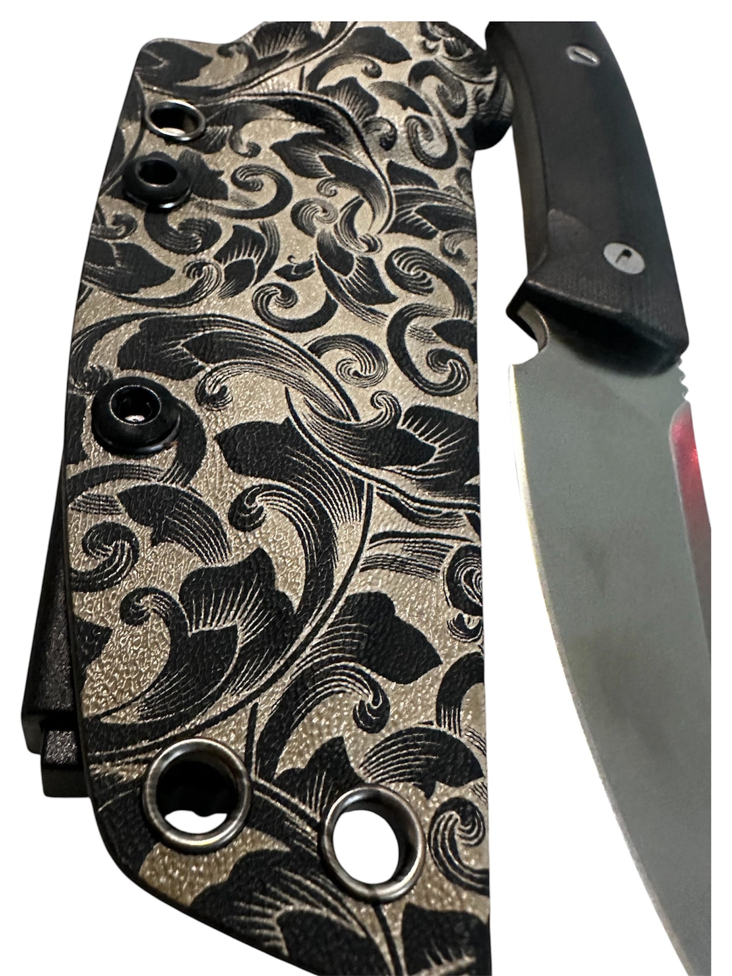 Compact 7-inch D2 fixed blade featuring black Micarta scales, custom floral engraved Kydex sheath, black paracord lanyard, and complimentary RockinEDC Steel Wax.